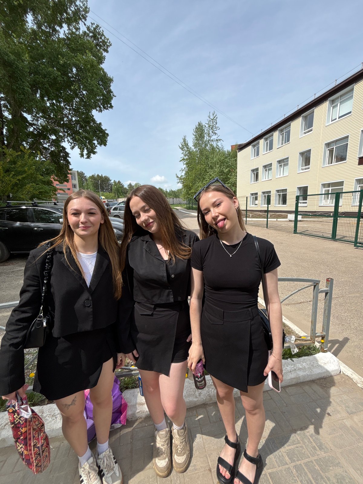 Young women gather for photos on Chaikovsky sidewalk