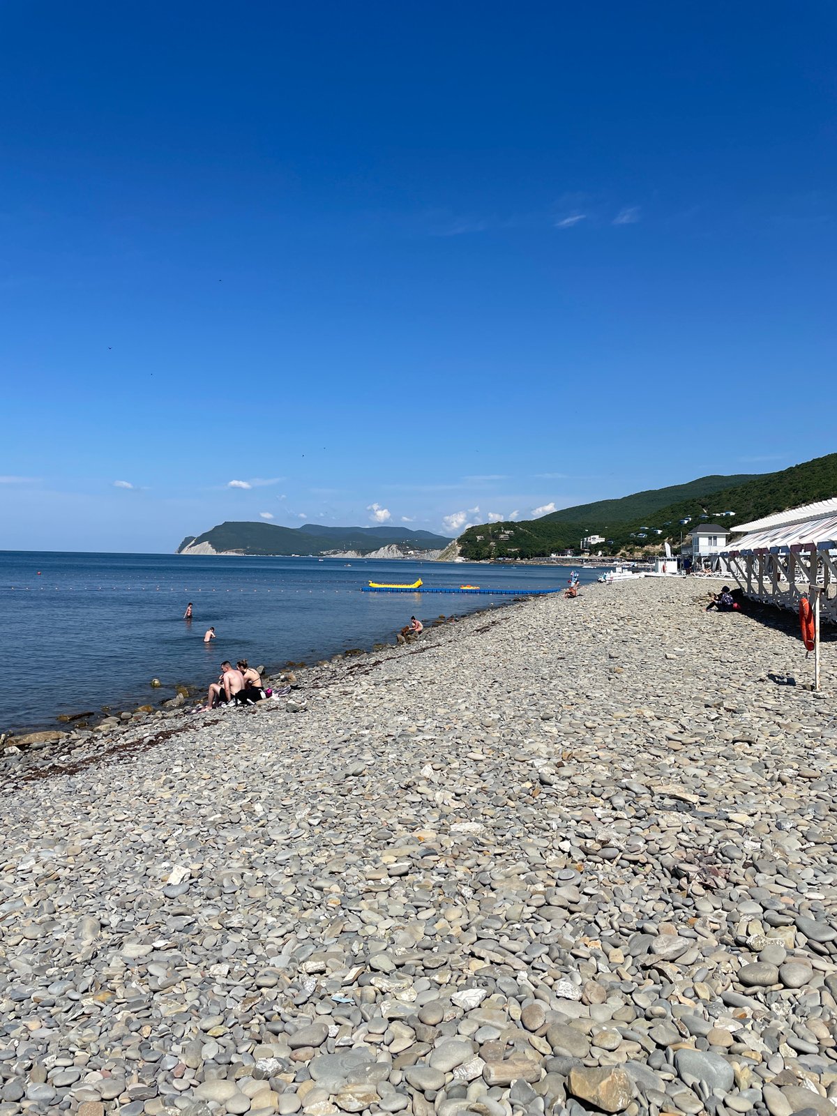 Calm summer morning at Shirokaya Balka's Black Sea pebble beach