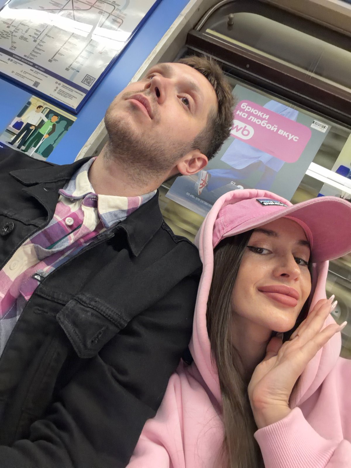 Couple photographs moments together in Saint Petersburg Metro system