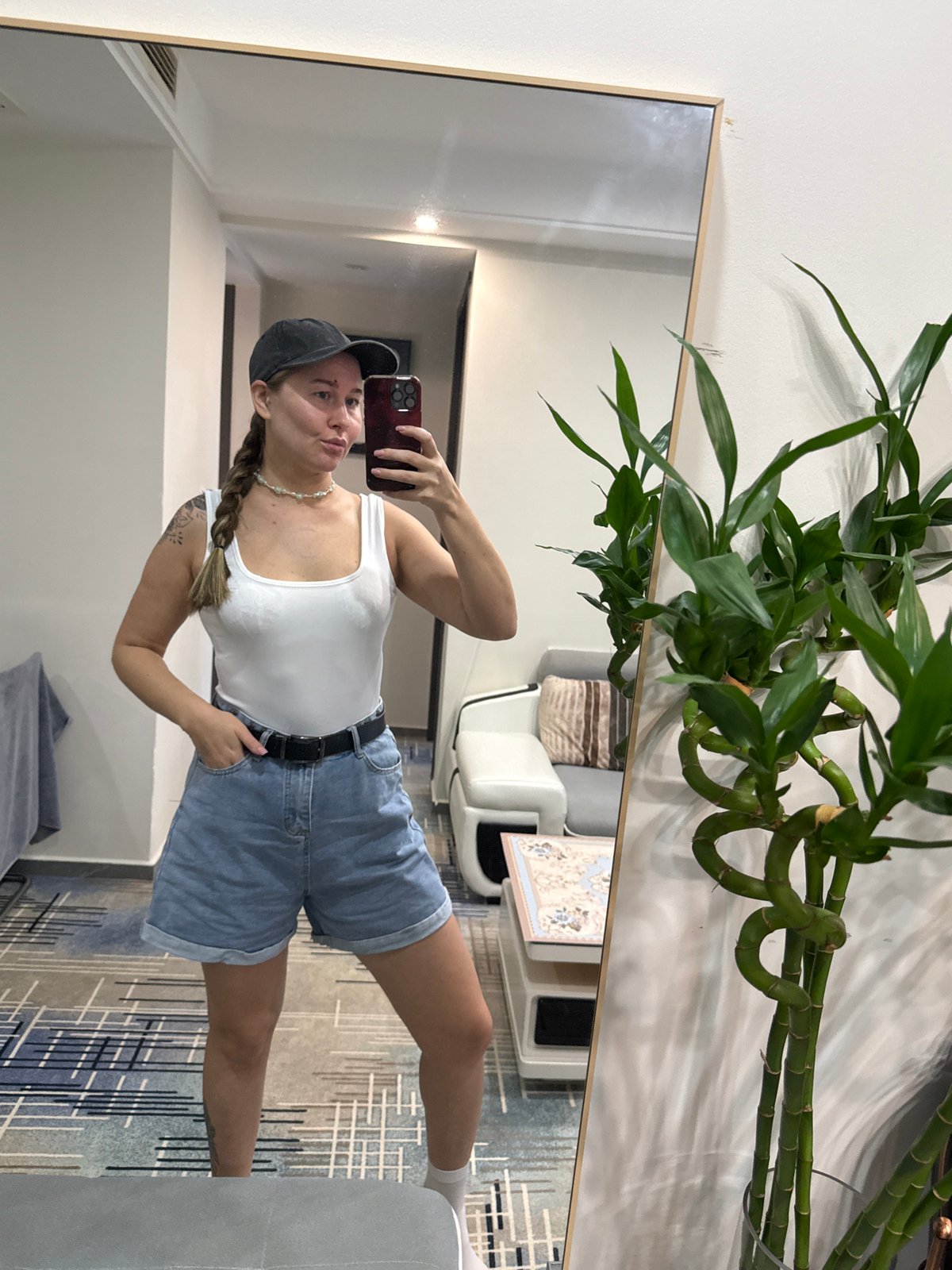 Mirror selfie in a Yiwu hotel room, casual outfit check