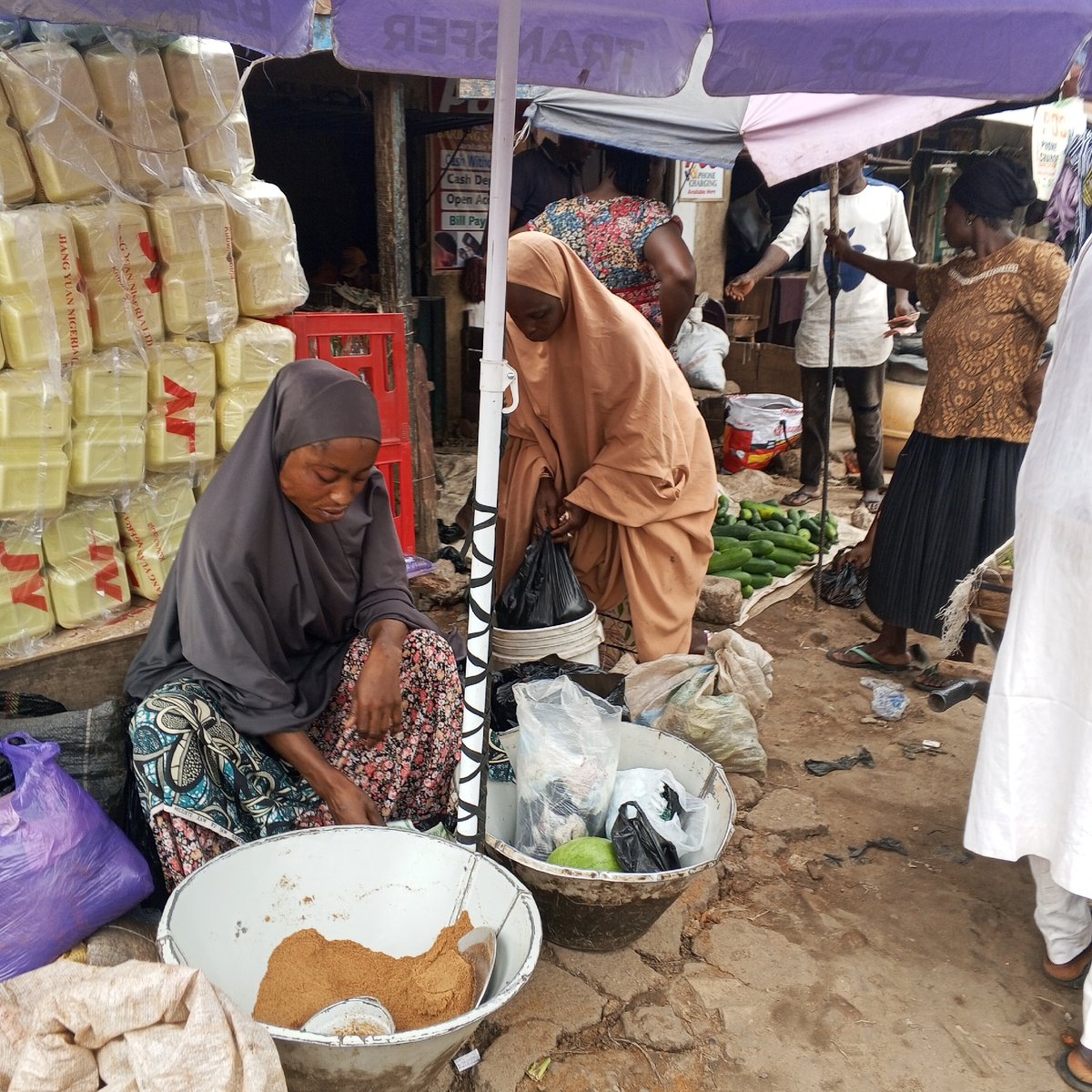 Nigerian markets bustling with vendors, produce, promotional activities