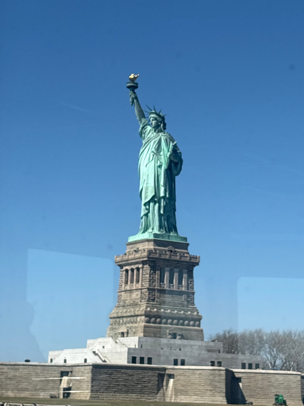 Statue of Liberty photographed from side angle in NYC harbor