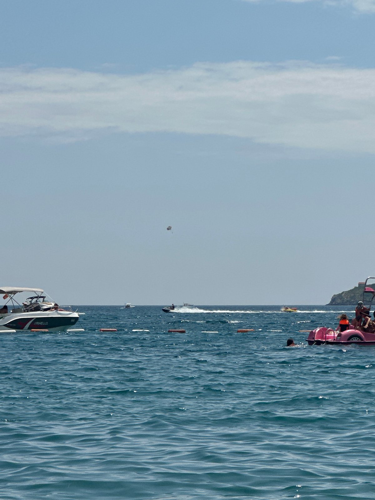 Boats and summer crowds on the water near Boreti, Montenegro