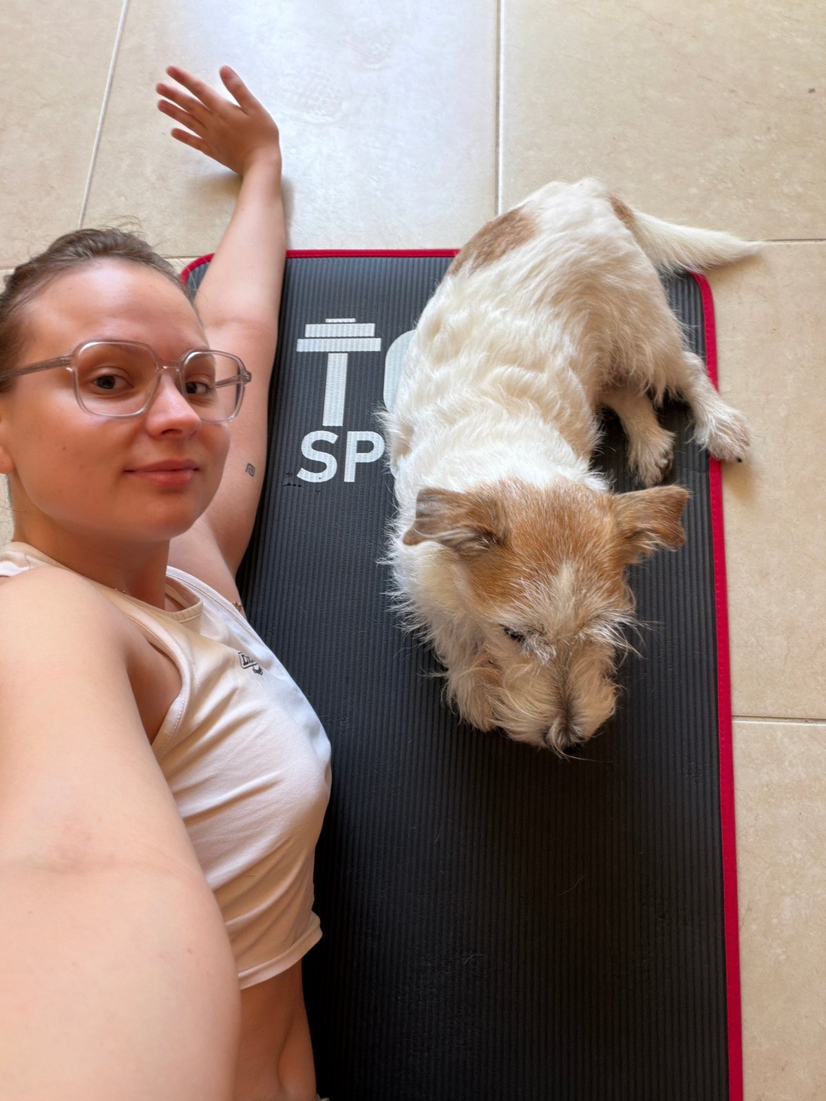 Woman exercises with small dog at Tel-Aviv home