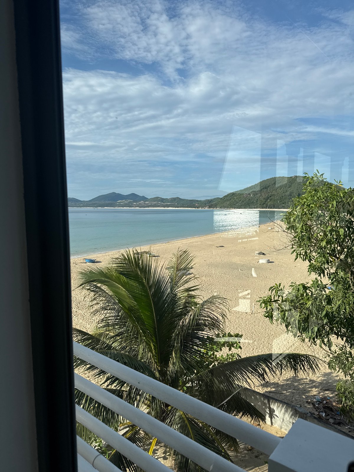 Lazy beach day views from a shaded balcony overlooking calm water