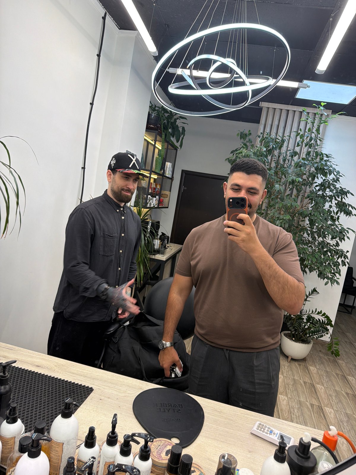 Two men interact indoors in Krasnoyarsk, Russia