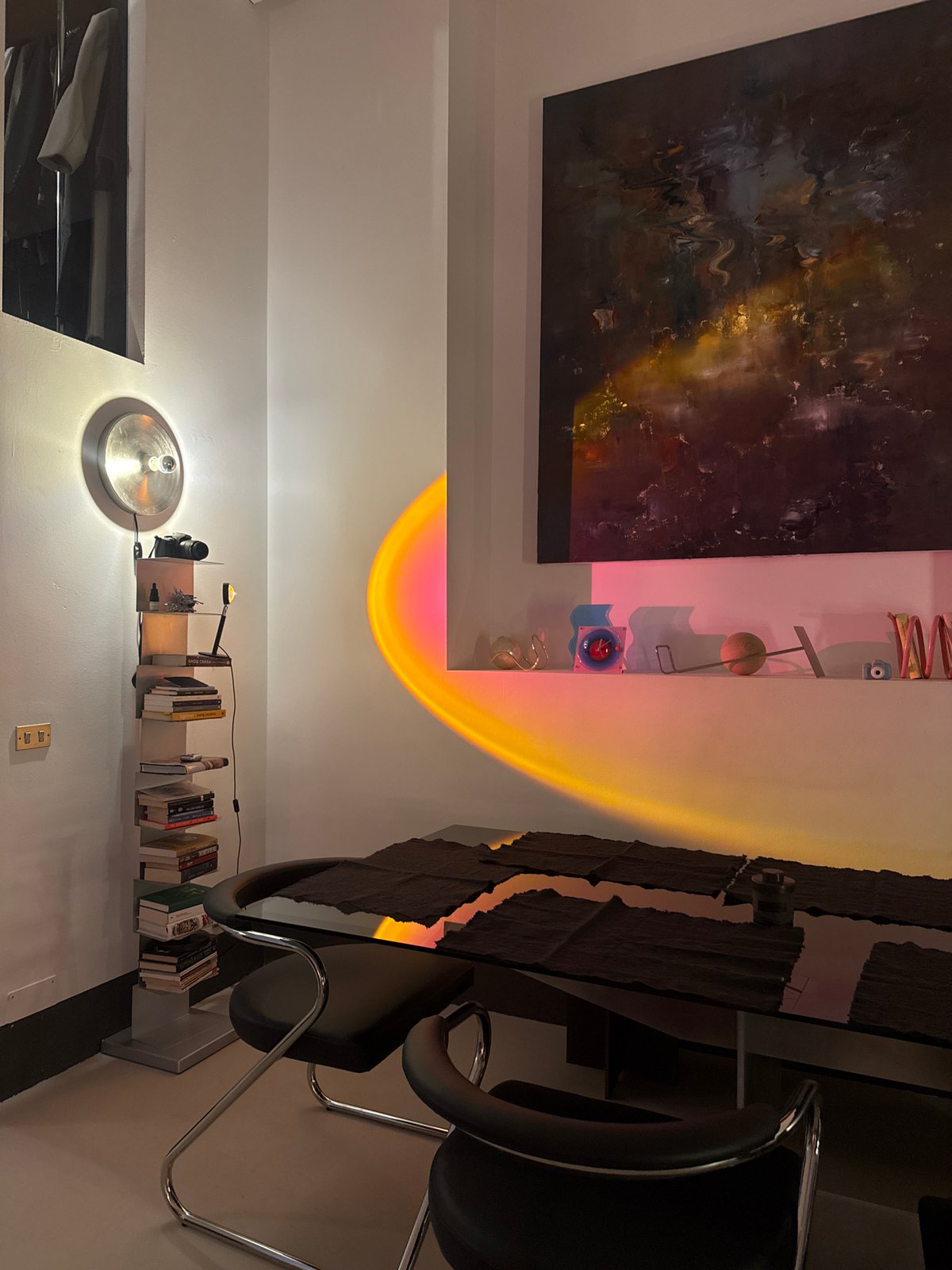 Milan interior space documented with art, books, pink mirror