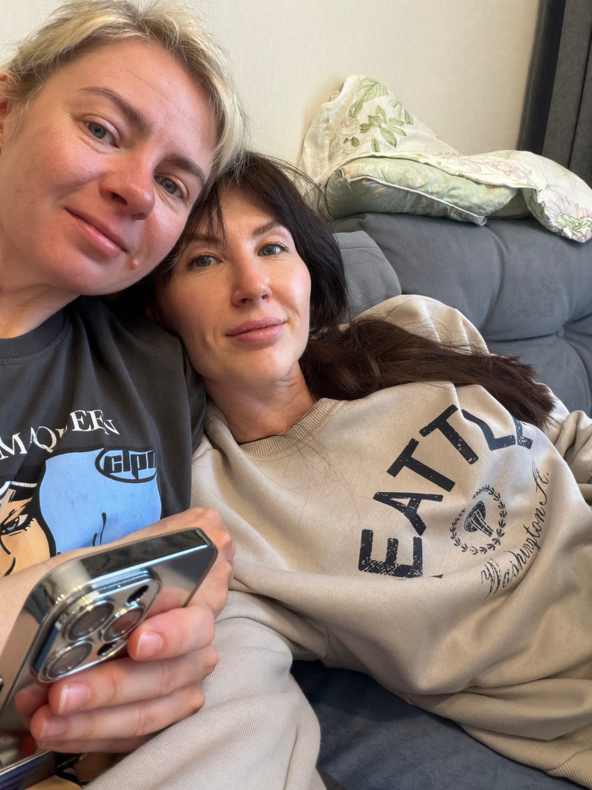 Two women relax on sofa in Perm apartment