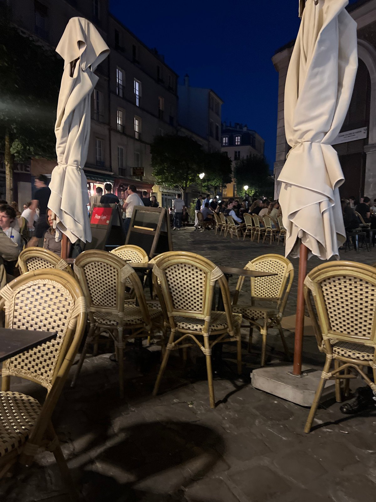 Versailles café terrace winding down at dusk