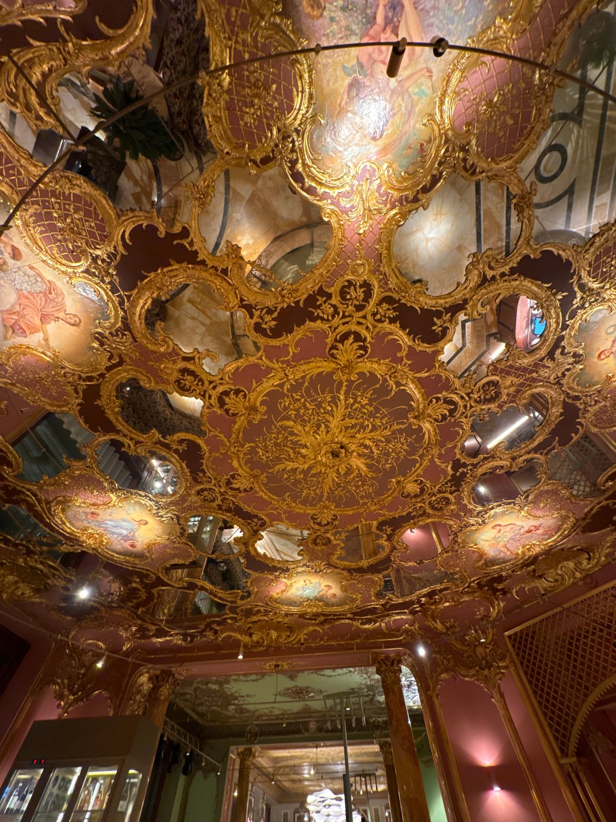 Ornate Moscow interior with gold ceiling and fountain documented