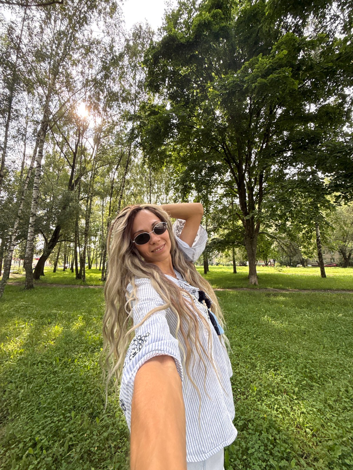 Sunny park afternoon in Rusanovo with a stroller in tow