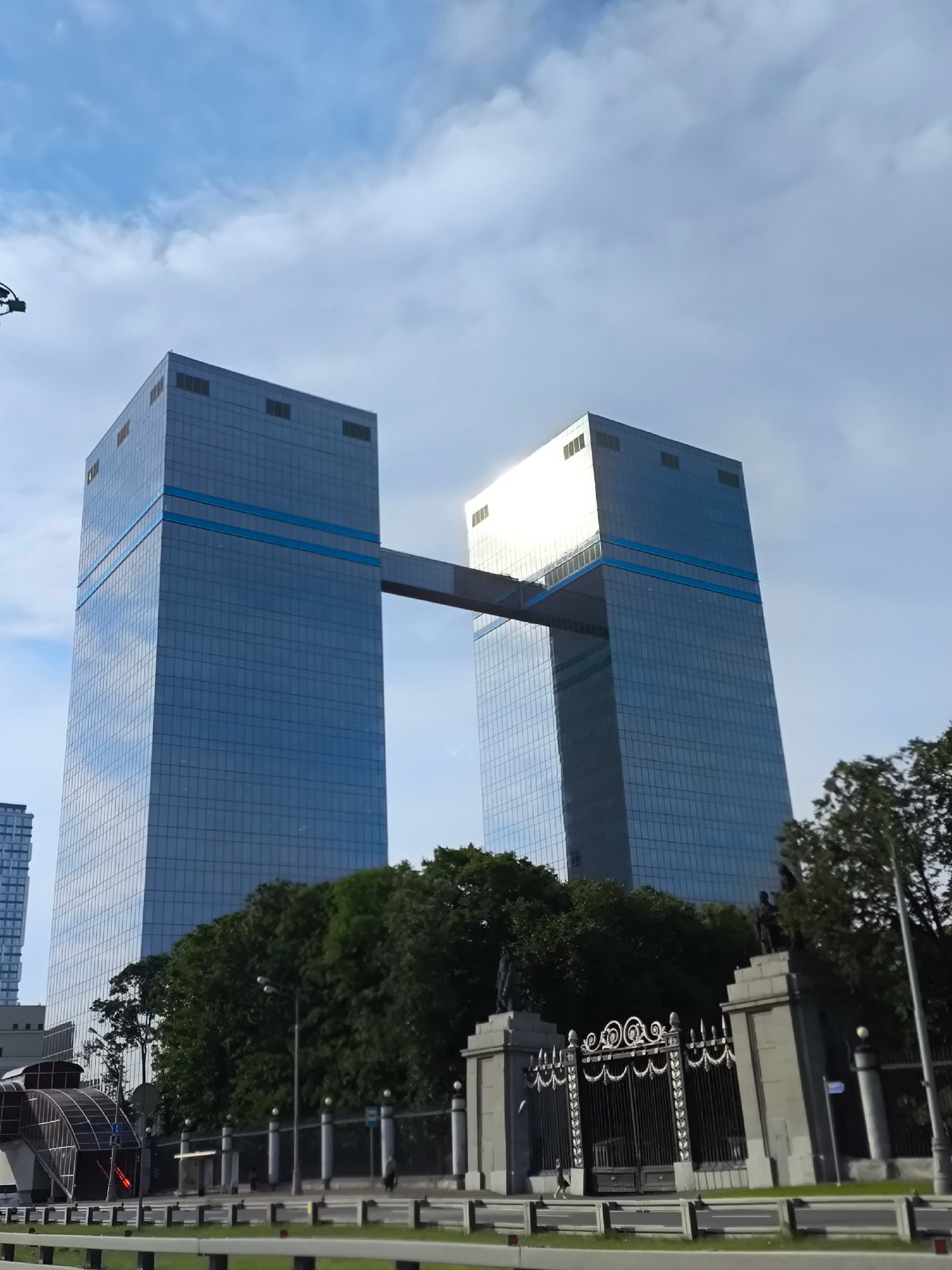 Glass towers, dealerships, and cranes define a growing commercial district