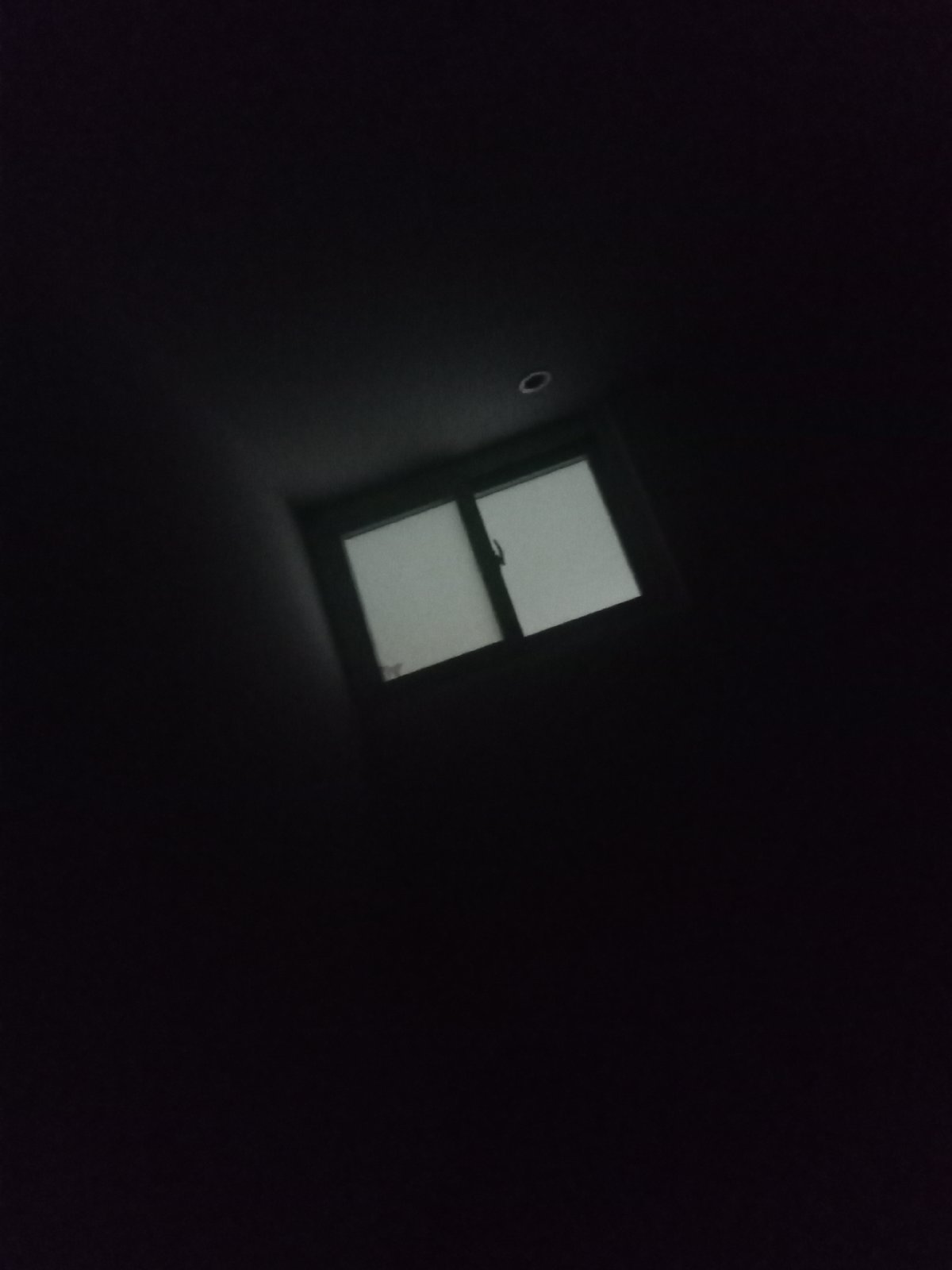 Dimly lit room and device screen captured in nighttime memories