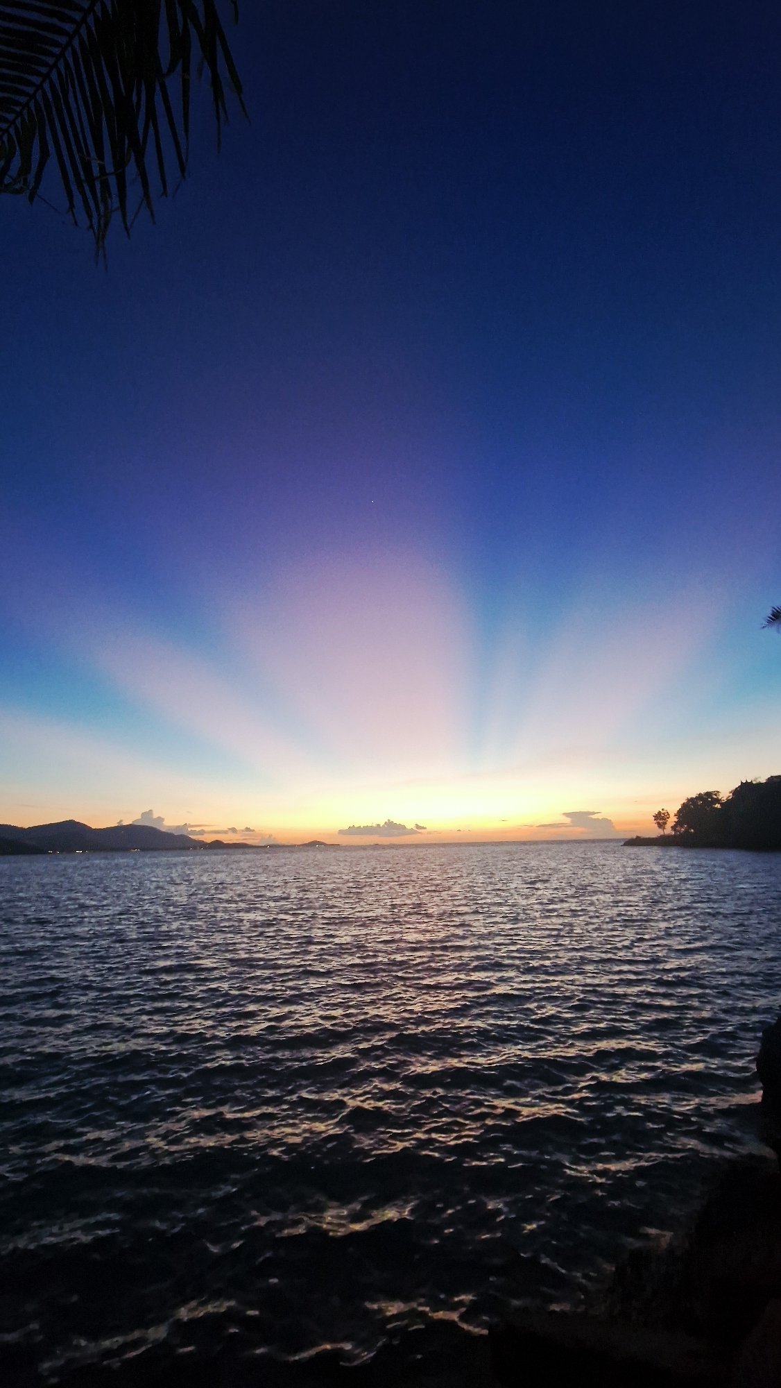 Rocky coastline sunset at Baan Plai Laem, Thailand