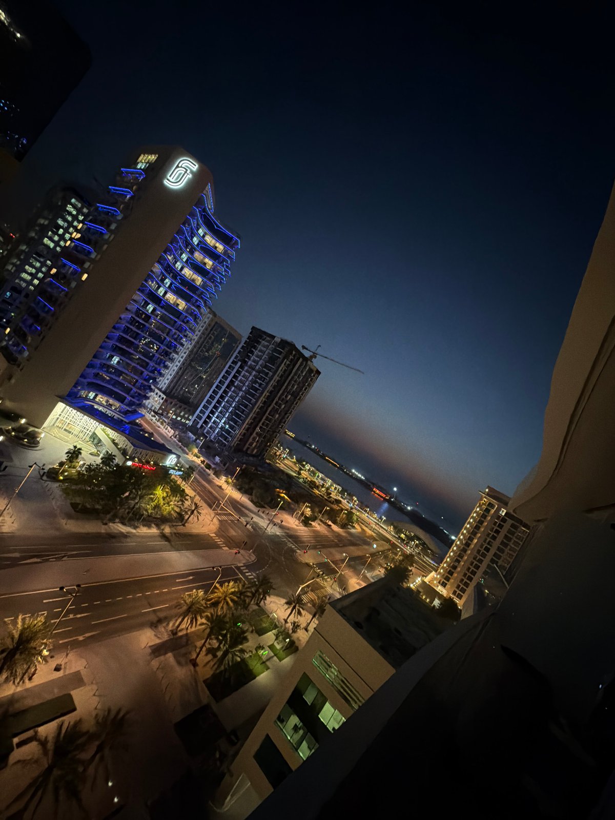 Lusail skyline glows at dusk along the harbor