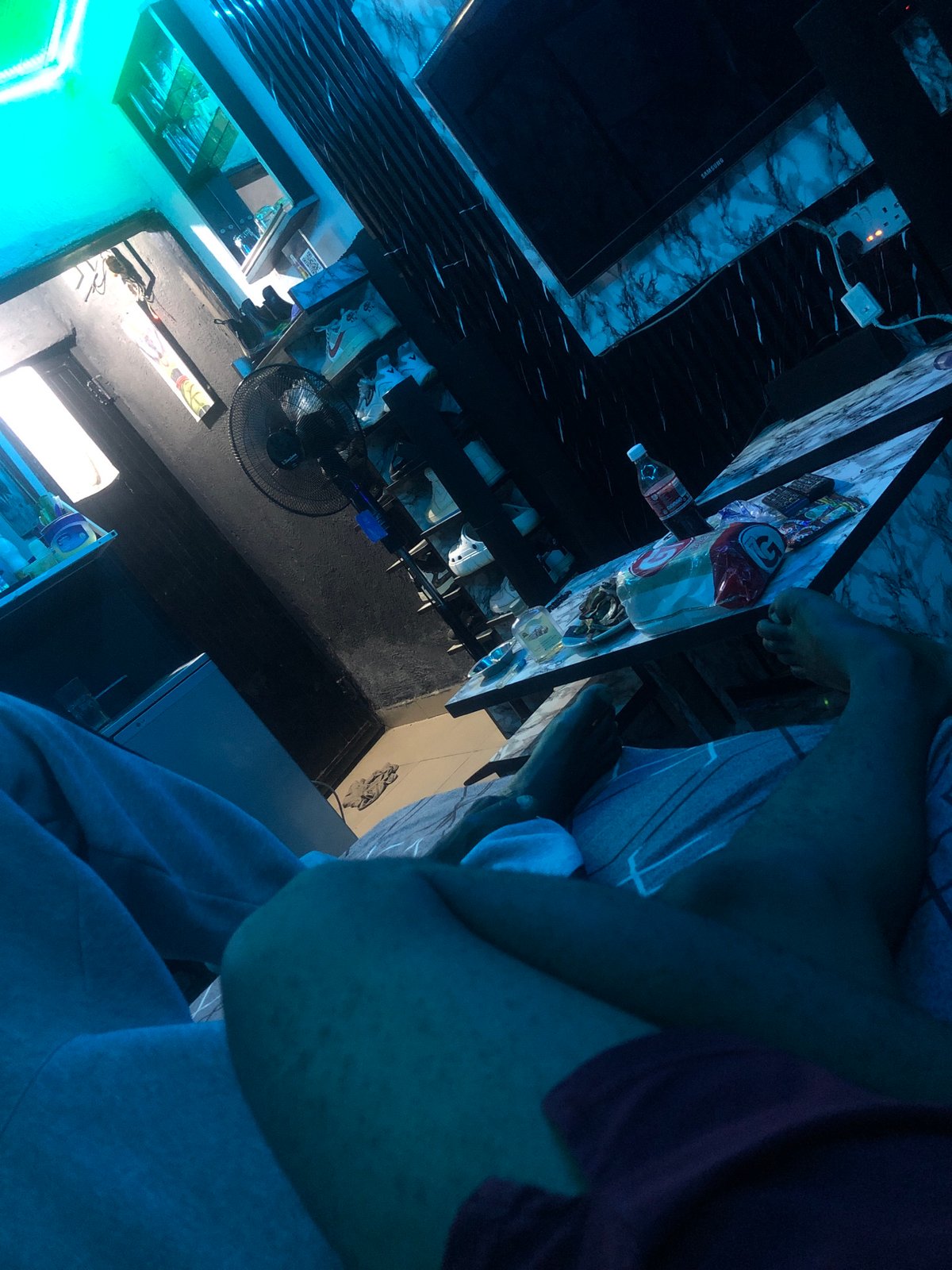 Person documents LED-lit room with spiritual text overlays