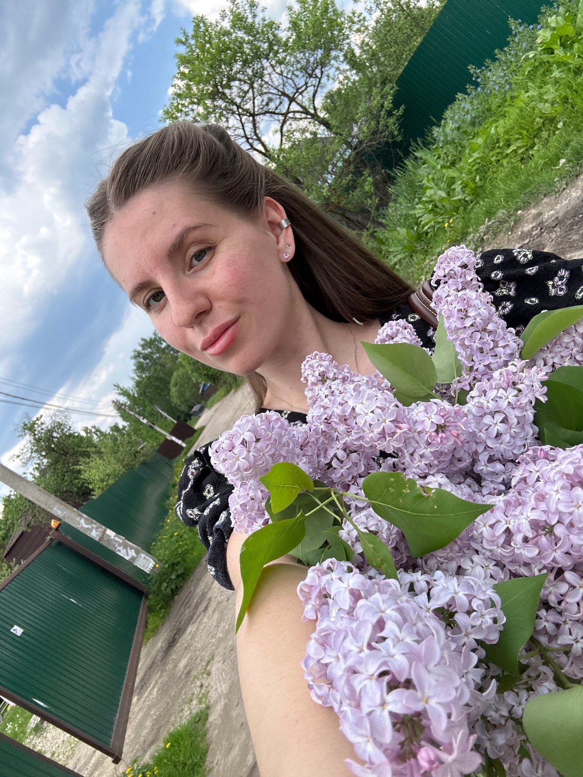 Woman enjoys quiet spring morning with flowers in Klin