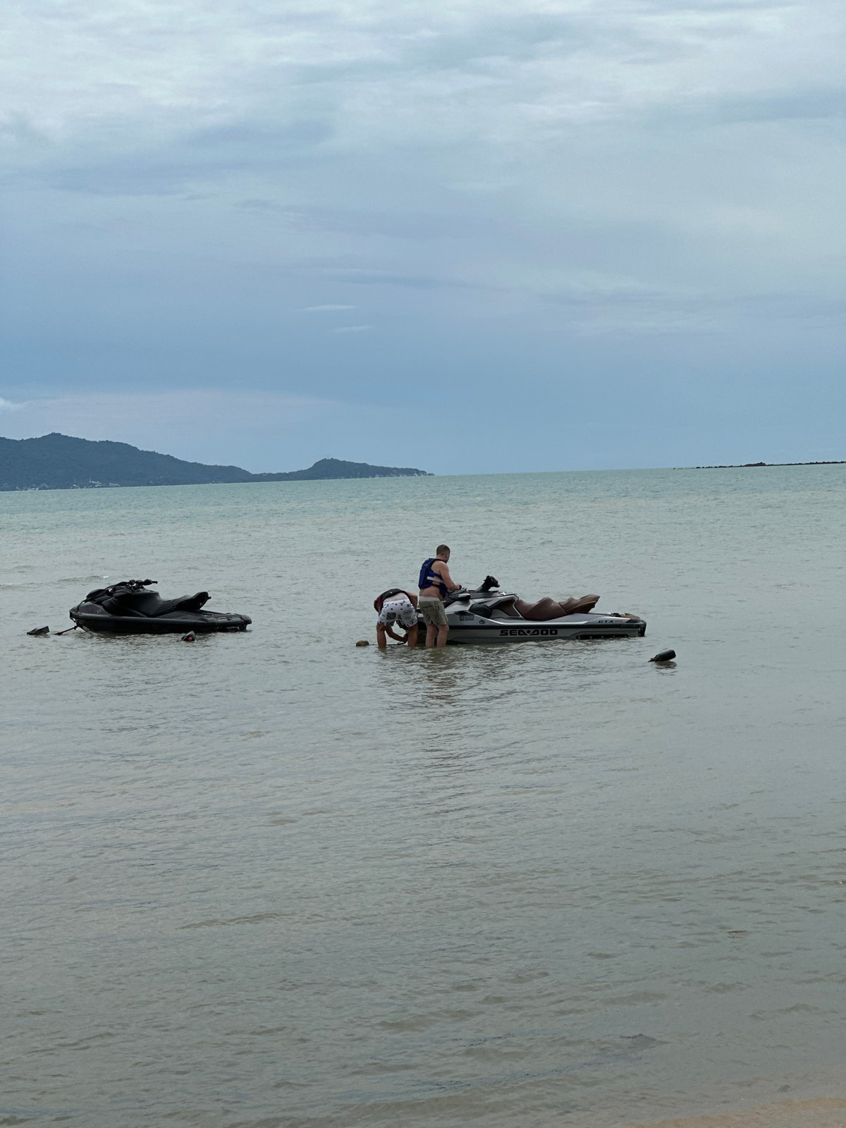 Jet skis and beach hut on a Ko Samui shoreline