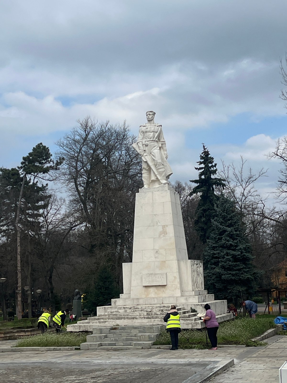 Workers maintain landscaping at soldier monument in Karnobat