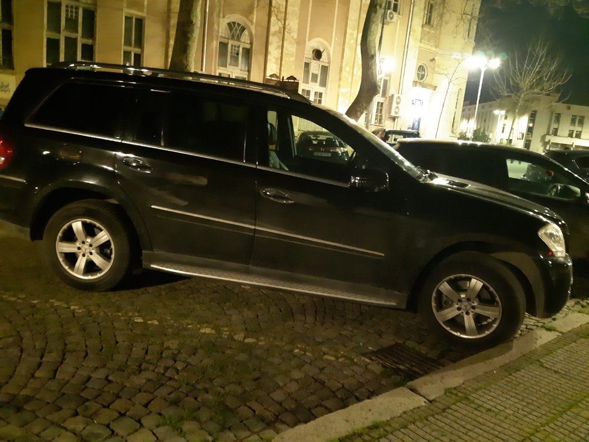 Evening street scene captured in historic Plovdiv with parked cars
