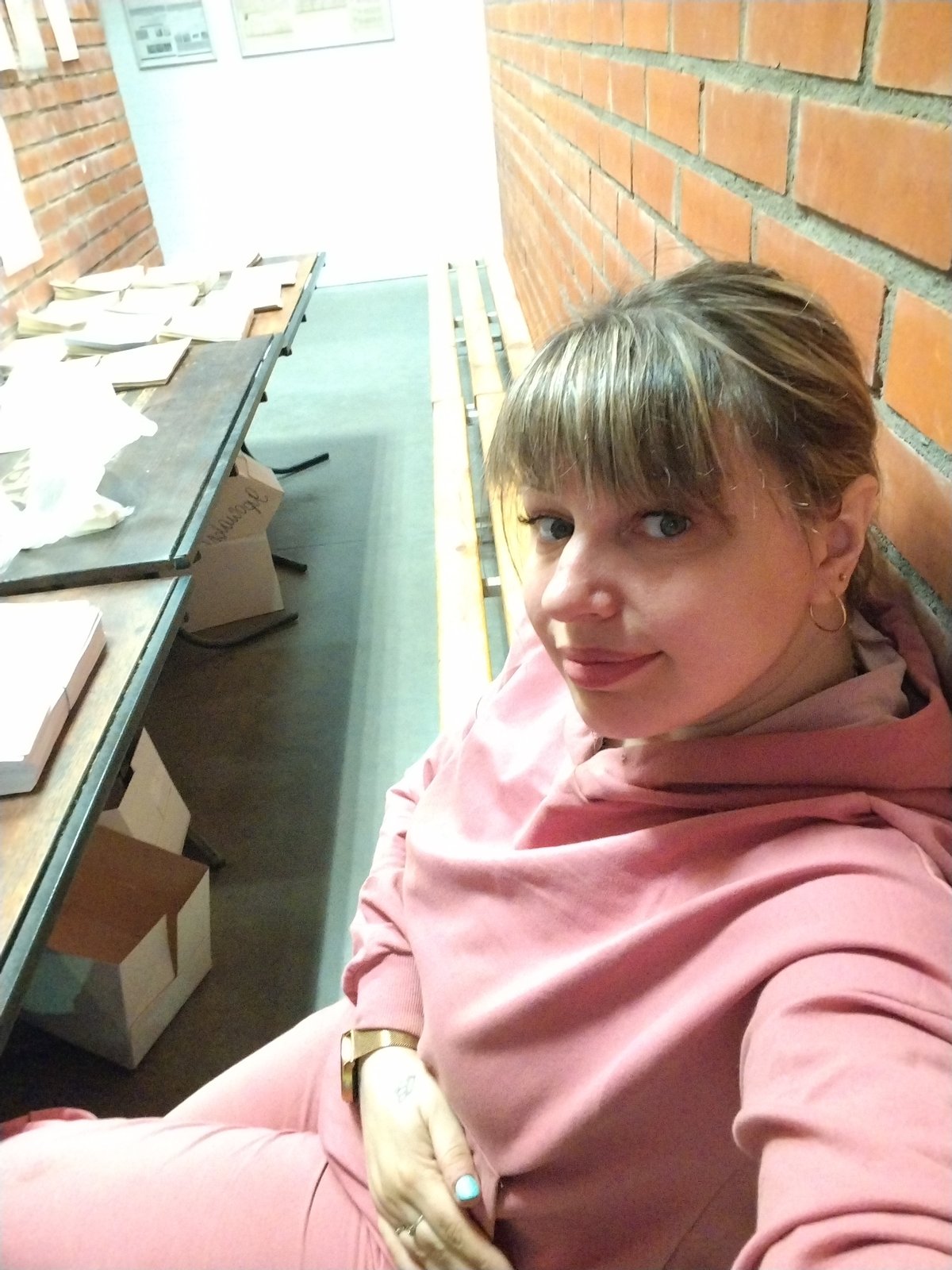 Woman in pink tracksuit photographed during evening in Rusanovo