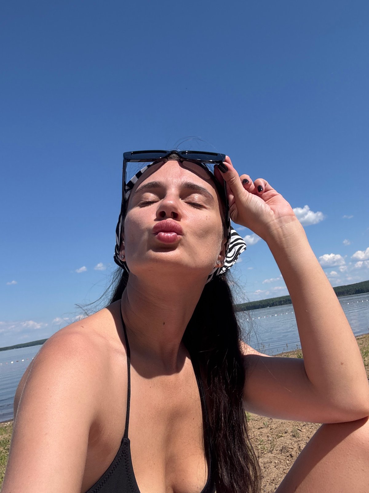 Woman takes beach selfies in Chaikovsky, Russia