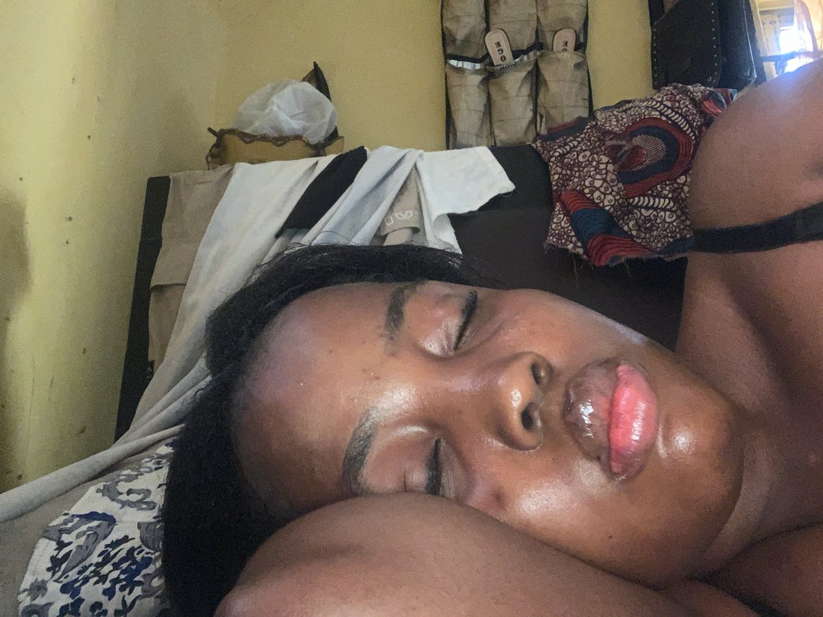 Person resting on patterned bedding in Aba home