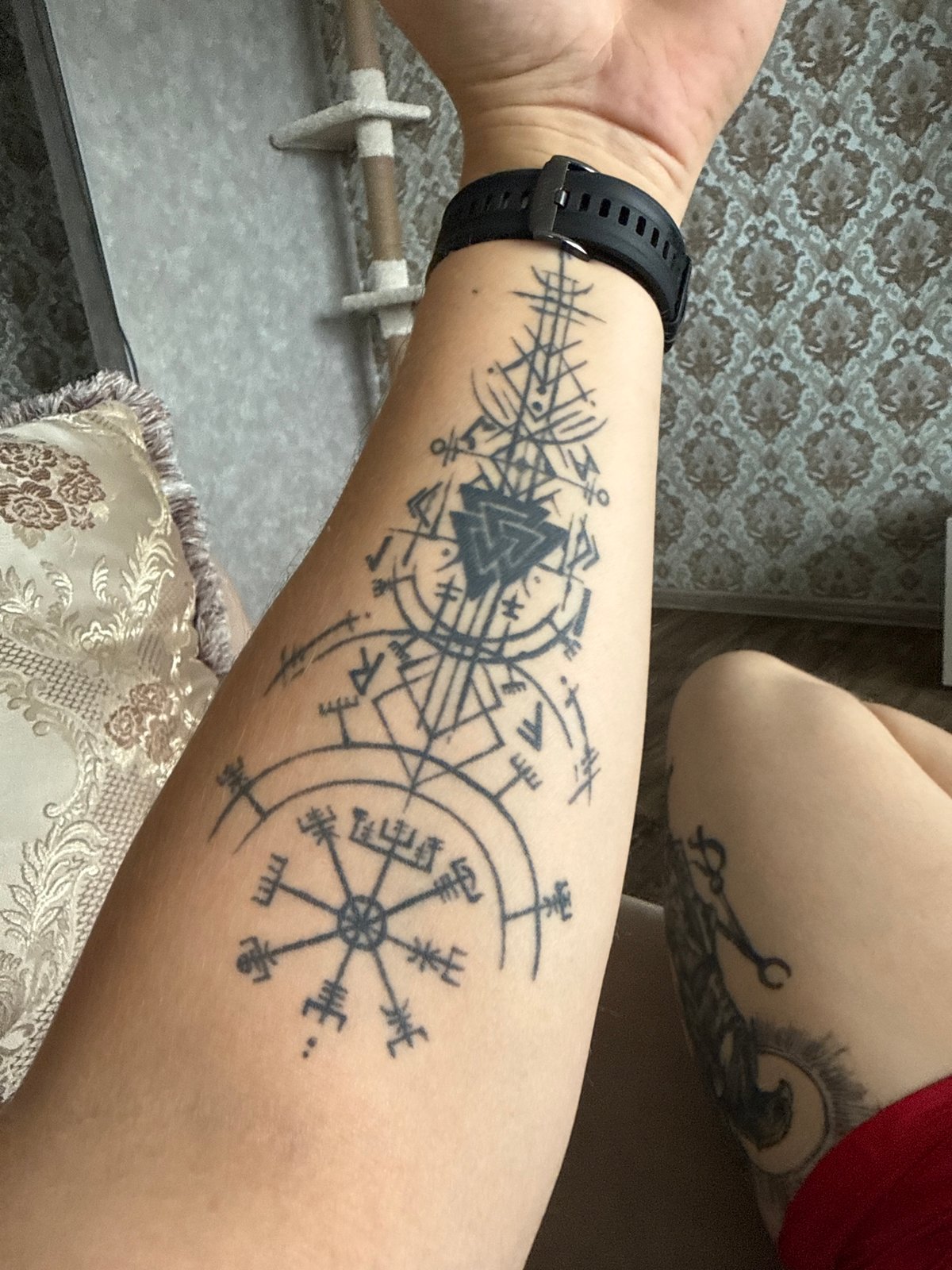 Esoteric tattoo work featuring runes, geometry, and Egyptian mythology