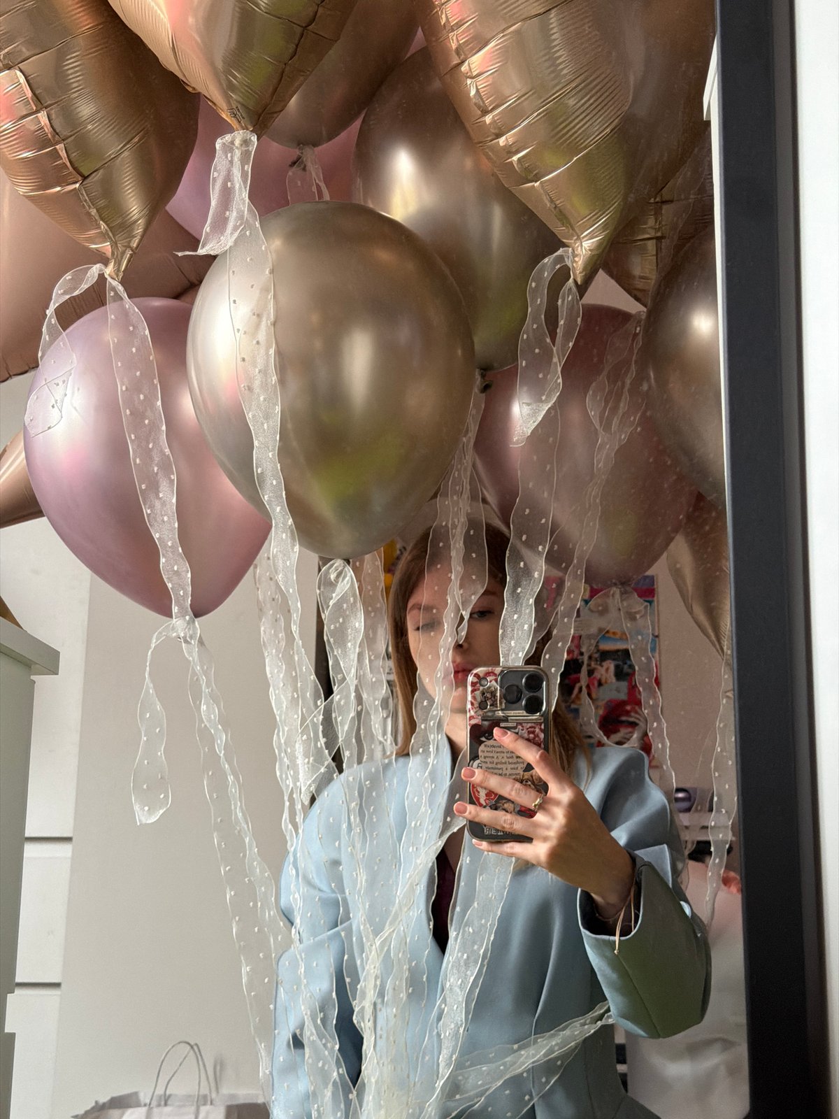 Woman celebrates with balloons and pink roses in Moscow