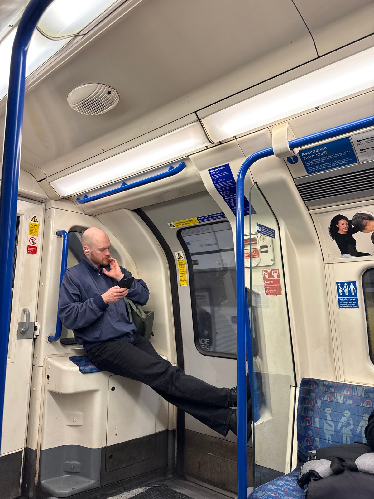 Man lies across wheelchair seats on London Underground train