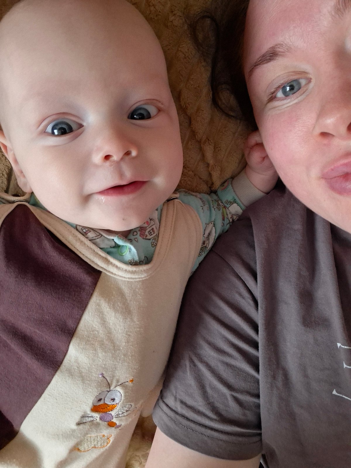 Adult and baby share quiet moment on textured surface