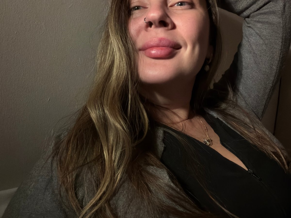 Woman takes selfies indoors in Moscow apartment with cat