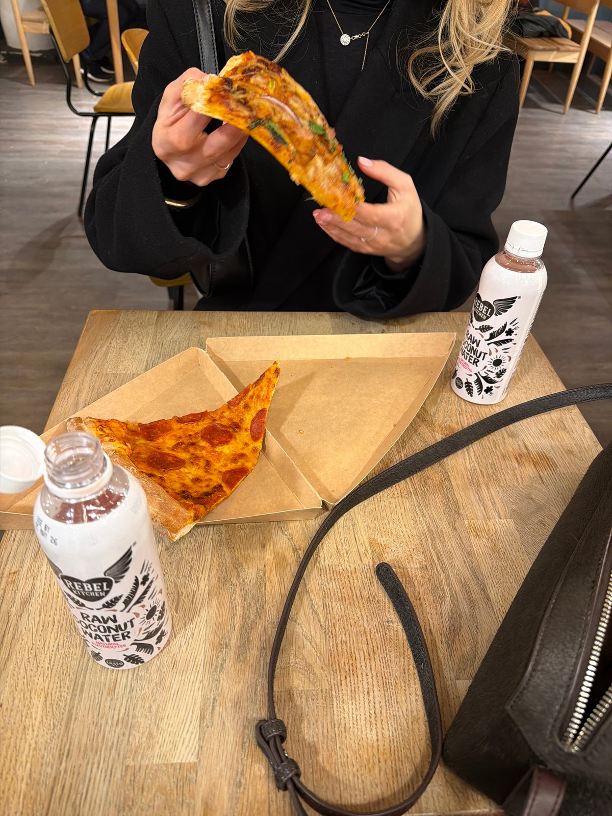 Woman enjoys pizza dinner in London