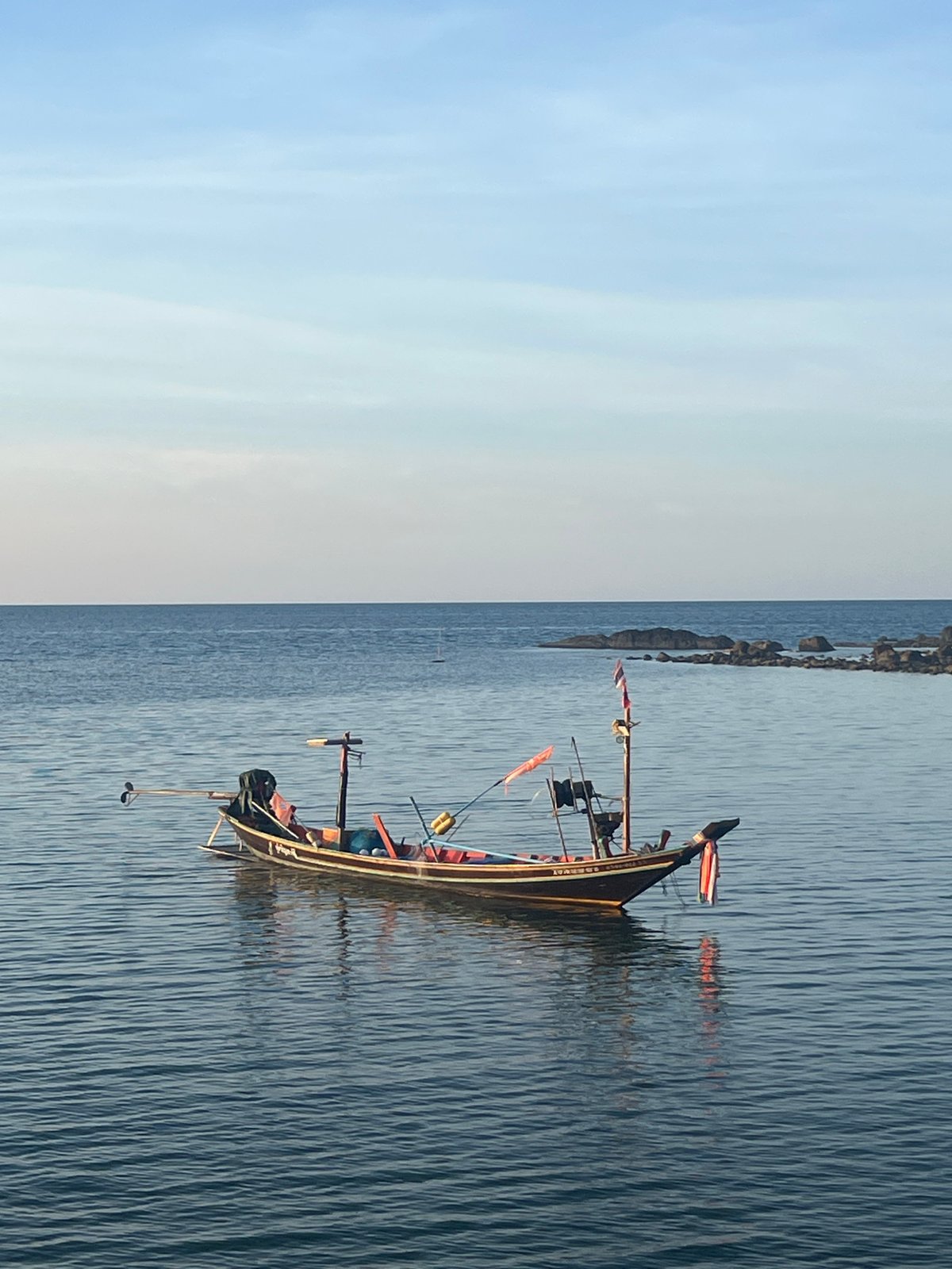 Golden hour along Ko Pha-ngan's coast, boats and calm water