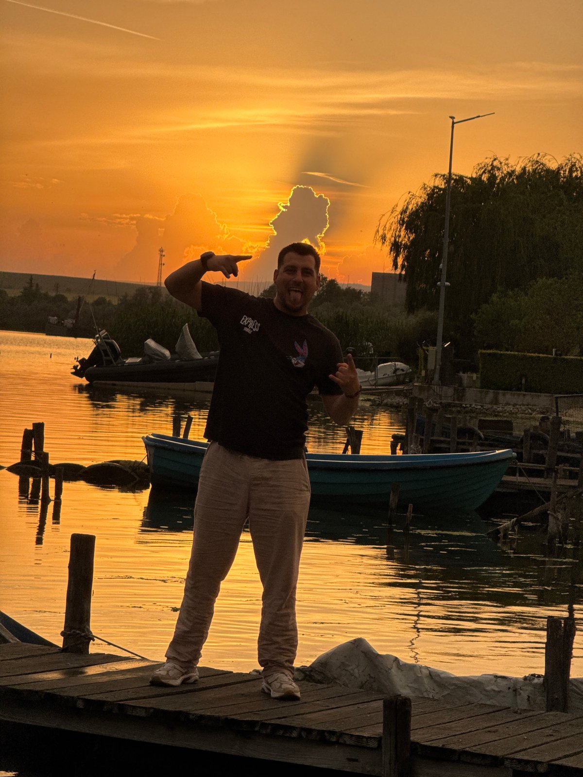 Sunset gathering at Bulgarian lakeside dock draws peaceful observers