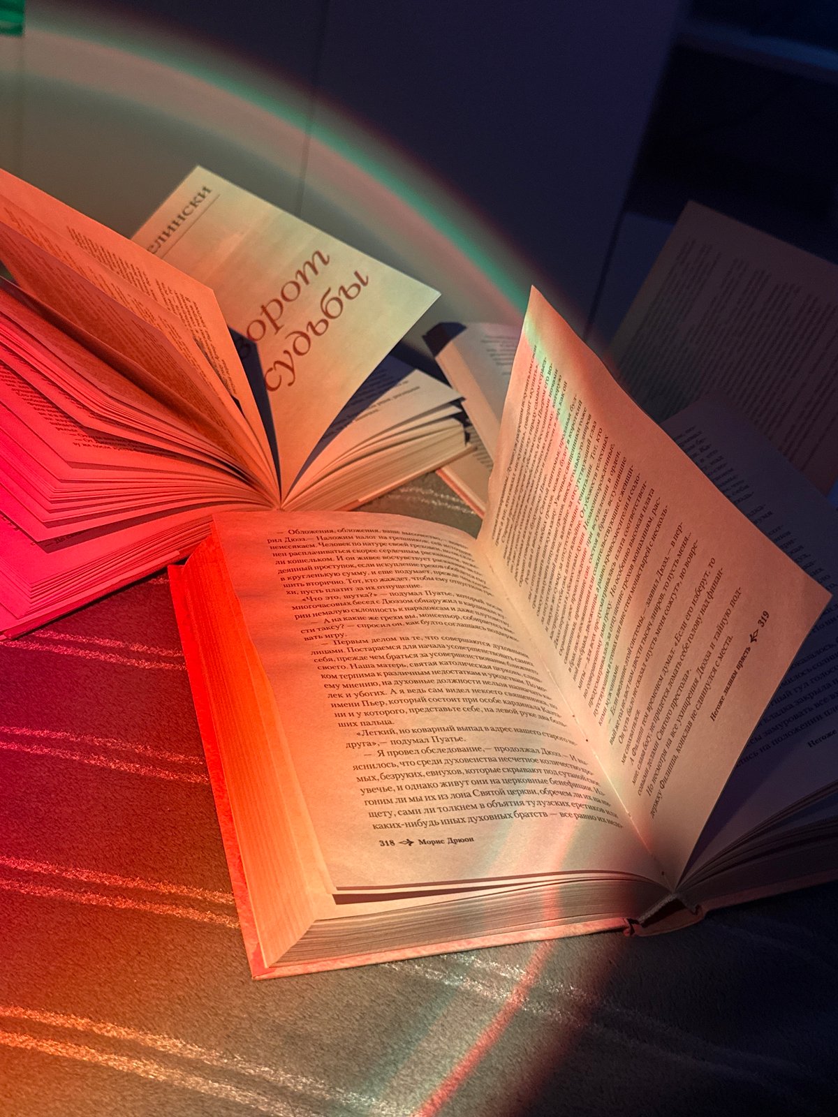 Person reads Russian books under rainbow lighting effects