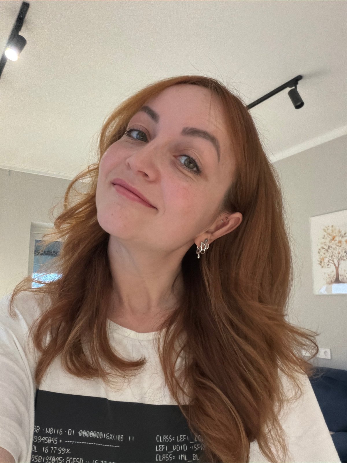 Woman photographed in mirror selfie, upward pose in Chaikovsky