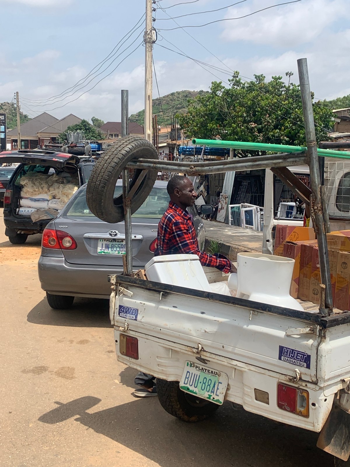 Midday street life and commerce in Gura Top, Nigeria