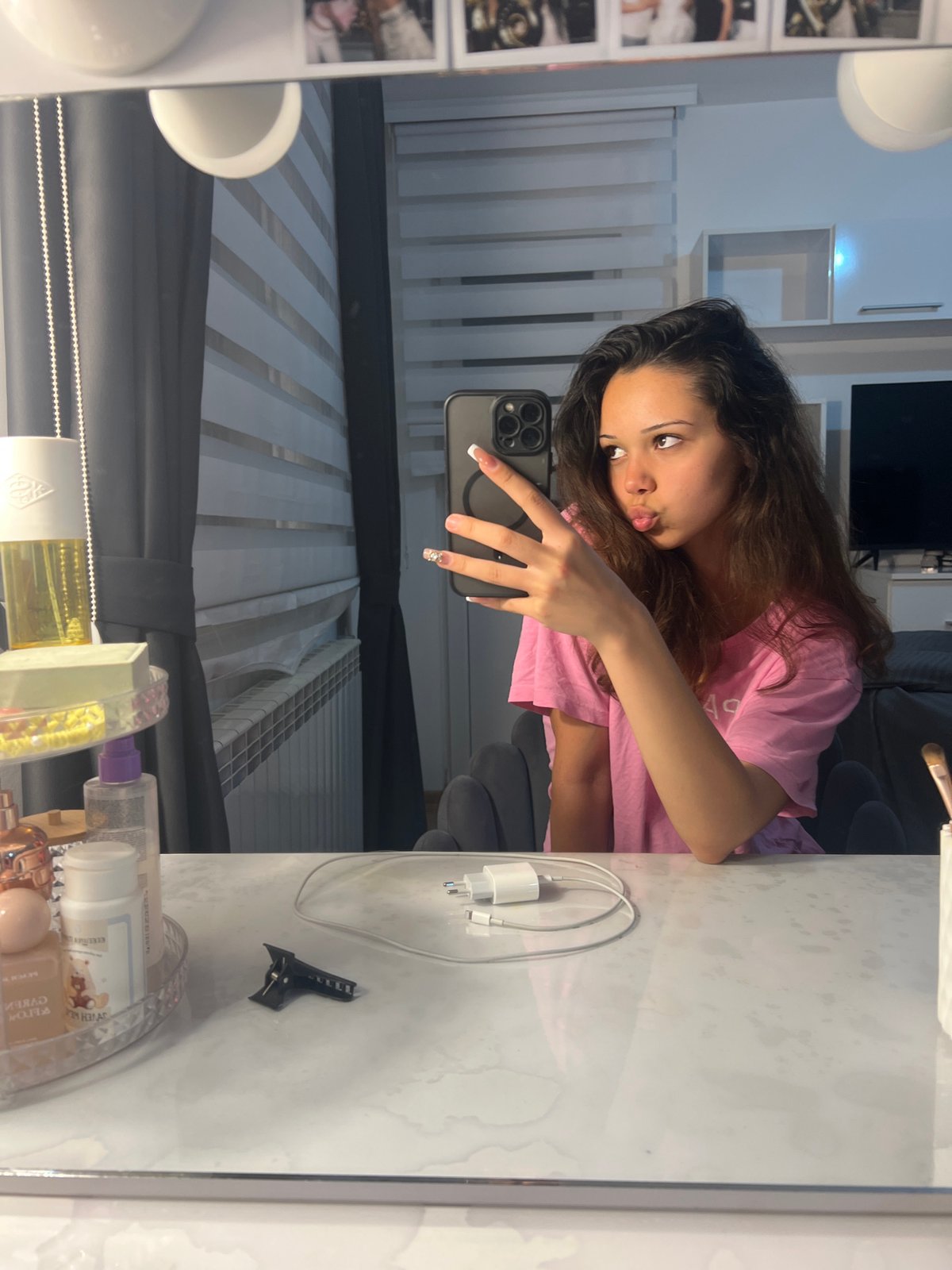 Woman takes multiple mirror selfies, Audi logo projection captured