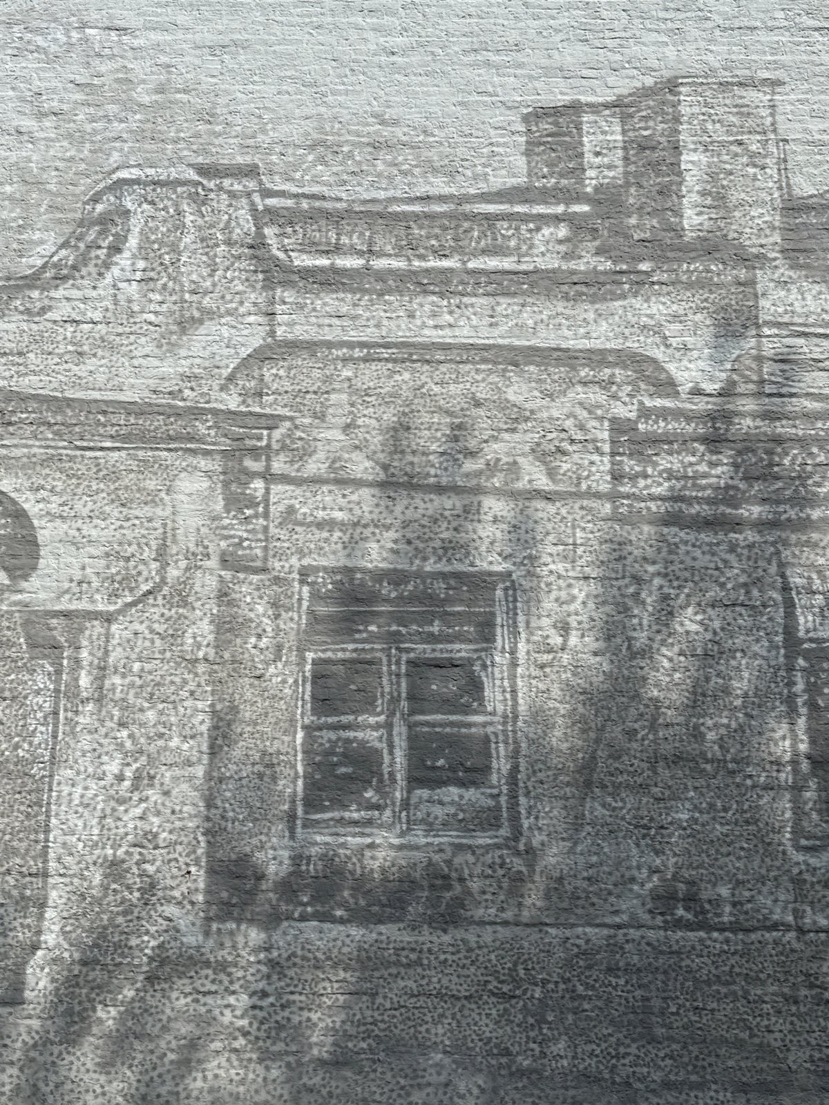 Moscow building mural with architectural details and tree shadows
