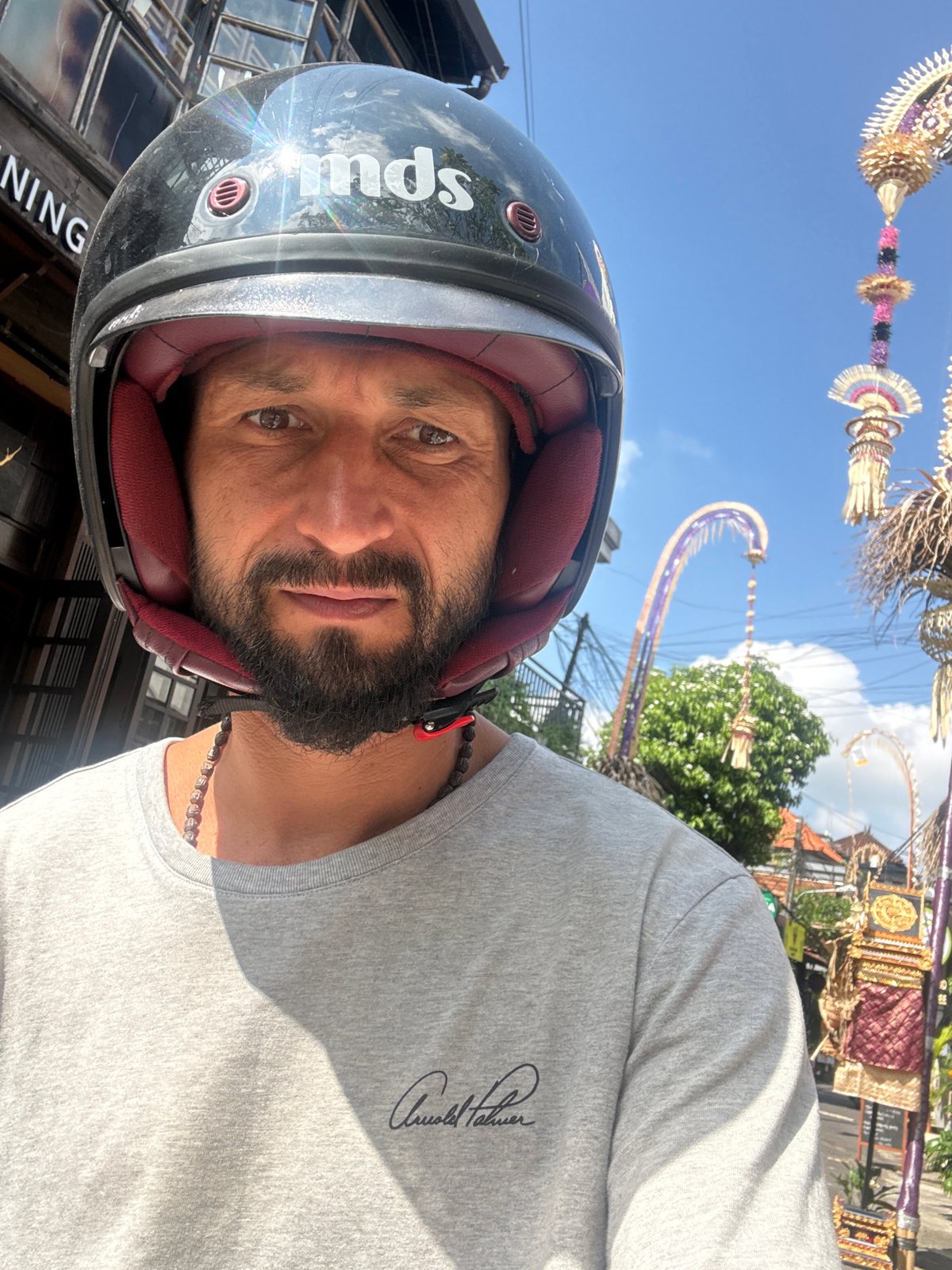 Helmeted rider and SUV on an Ubud road