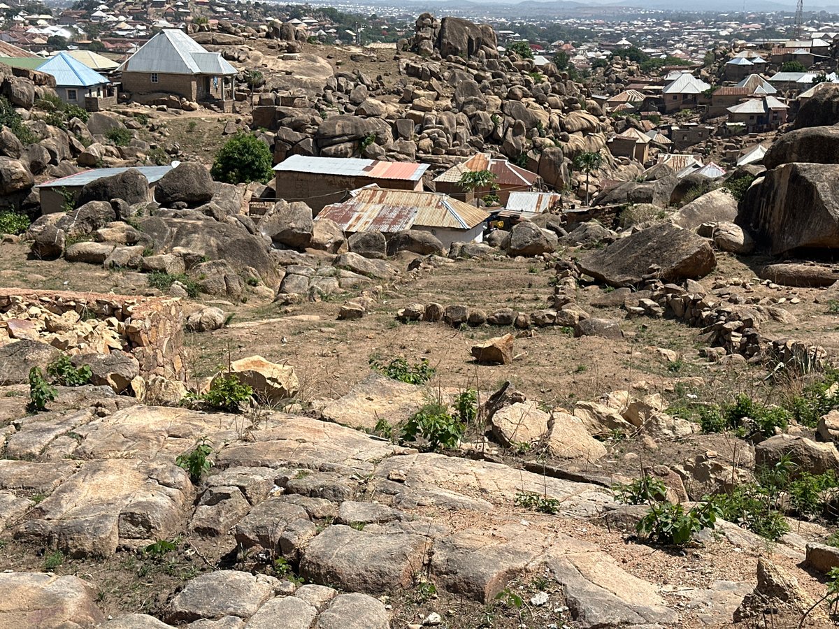 Rocky landscape with scattered buildings documented in Jos, Nigeria