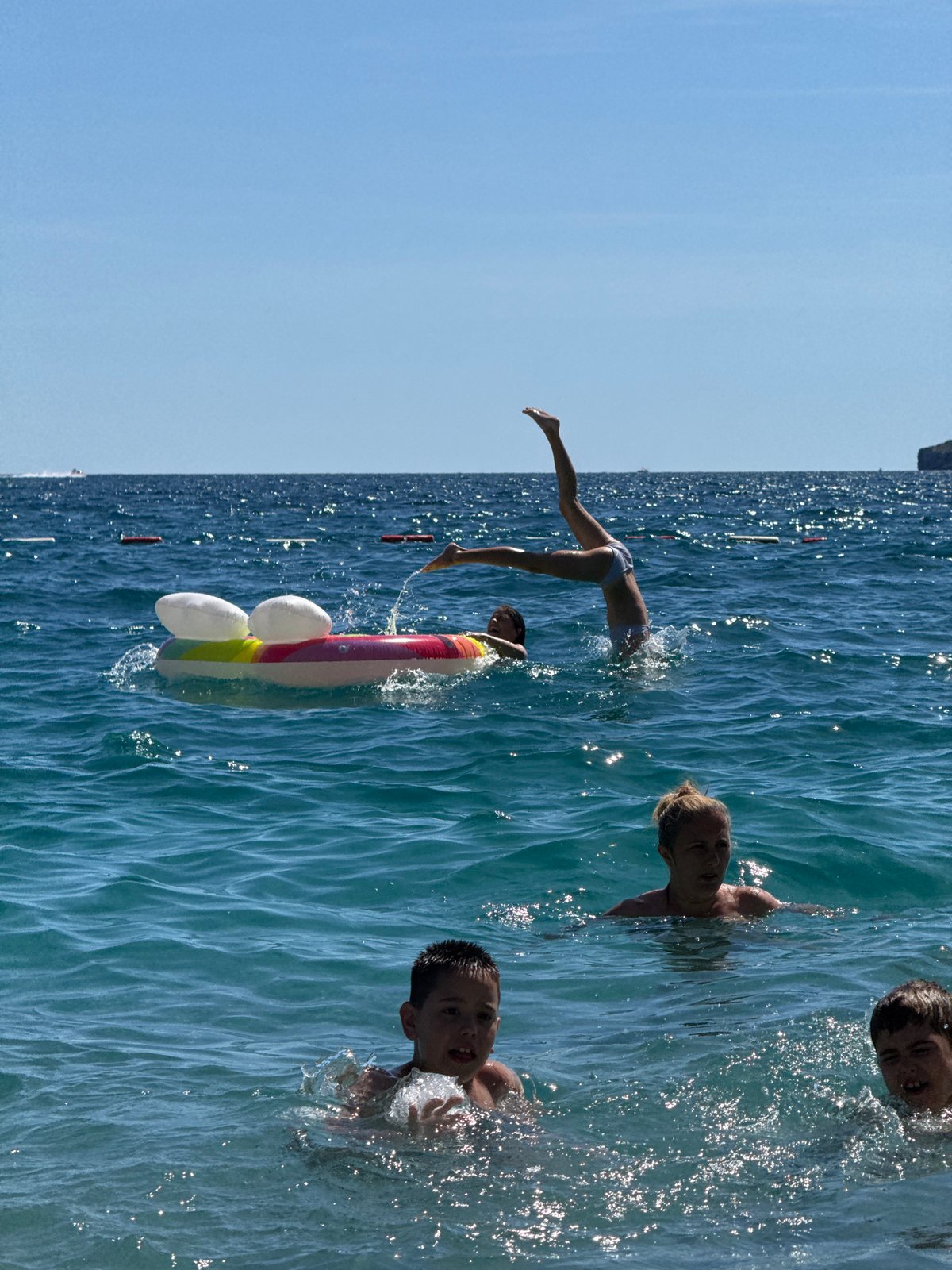 Summer beach day draws swimmers to Montenegro's Adriatic coast