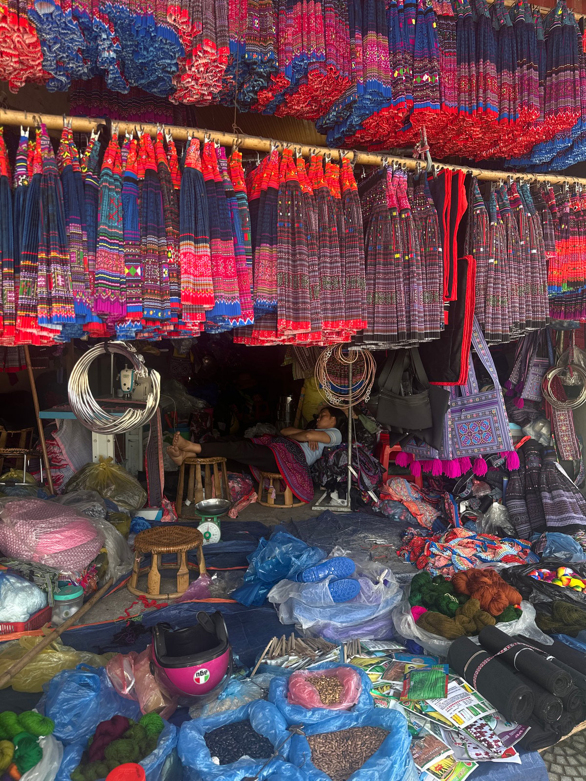 Traditional vendor weighs plums at Vietnam morning market