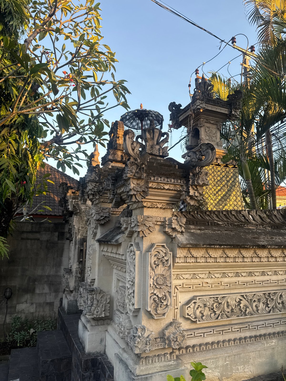Dusk in Denpasar: temple walls, full moon, and market shelves