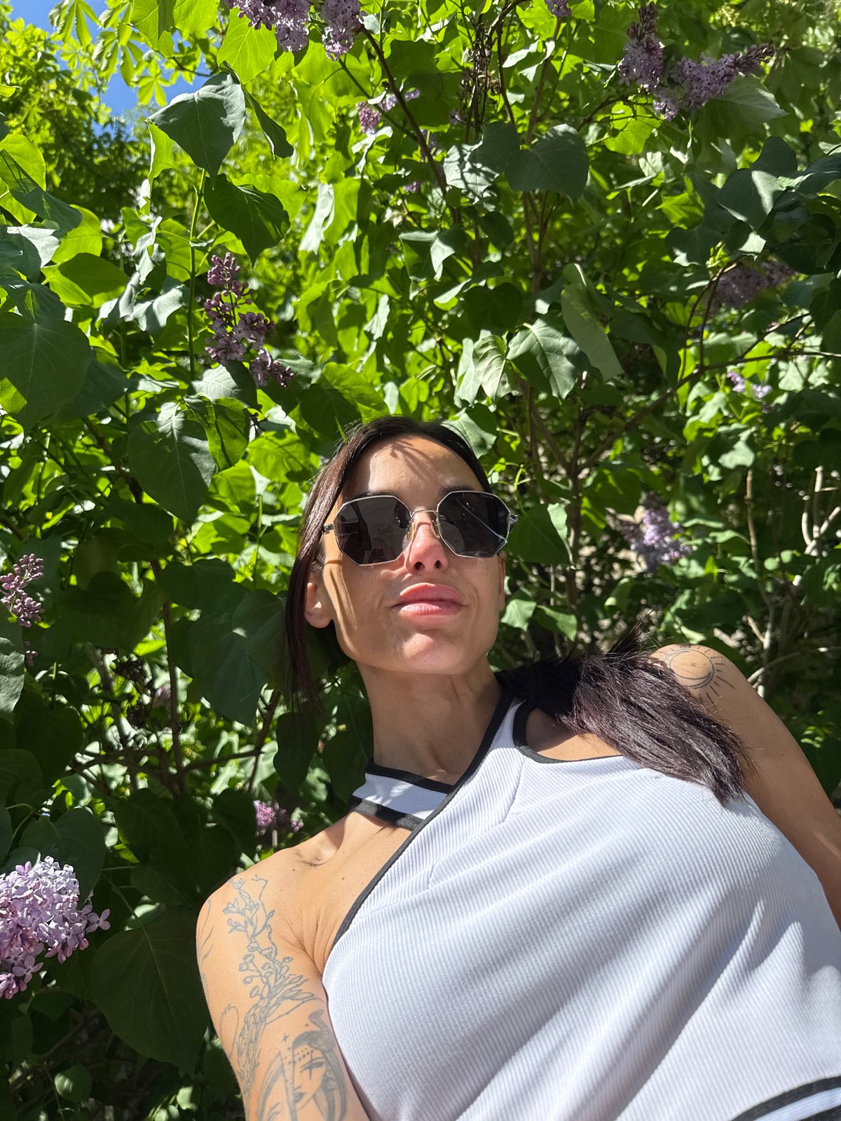 Woman photographed resting among lilac bushes in Pleven, Bulgaria