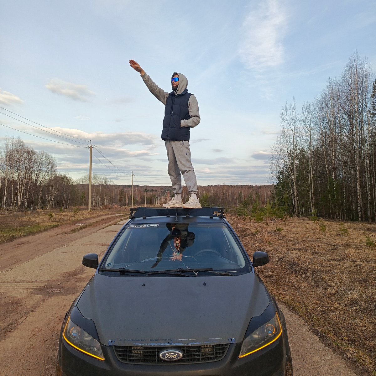 Man performs car stunts on dirt road in Марковский