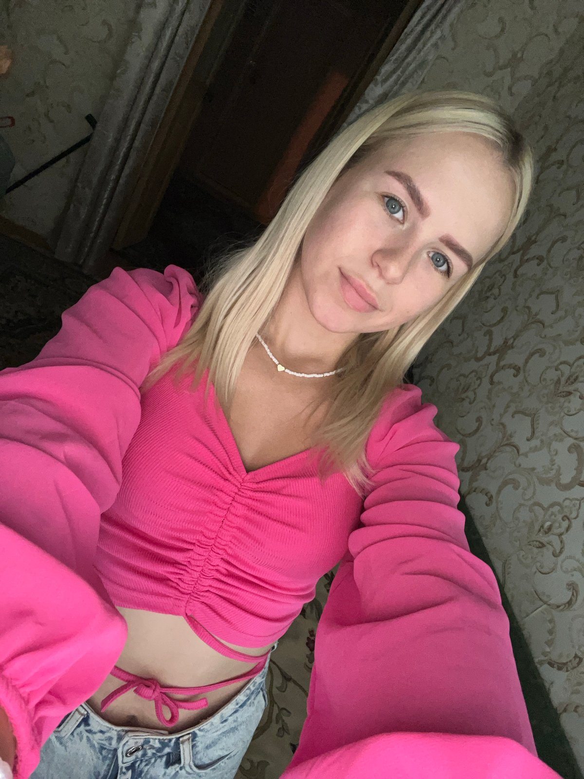 Multiple selfies, pink top and beaded necklace, same session
