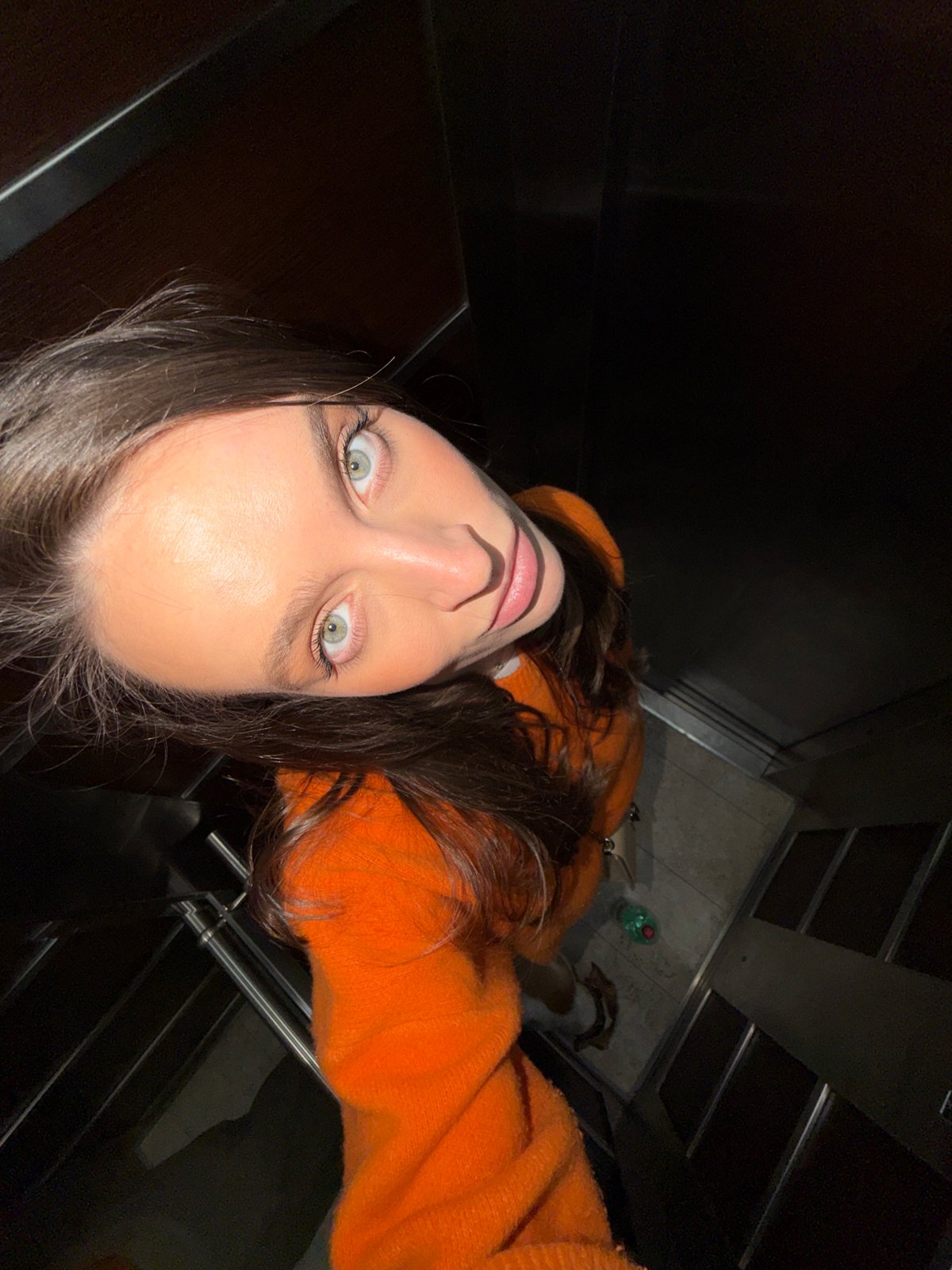 Woman takes selfies in elevator, walks through Budva parking garage