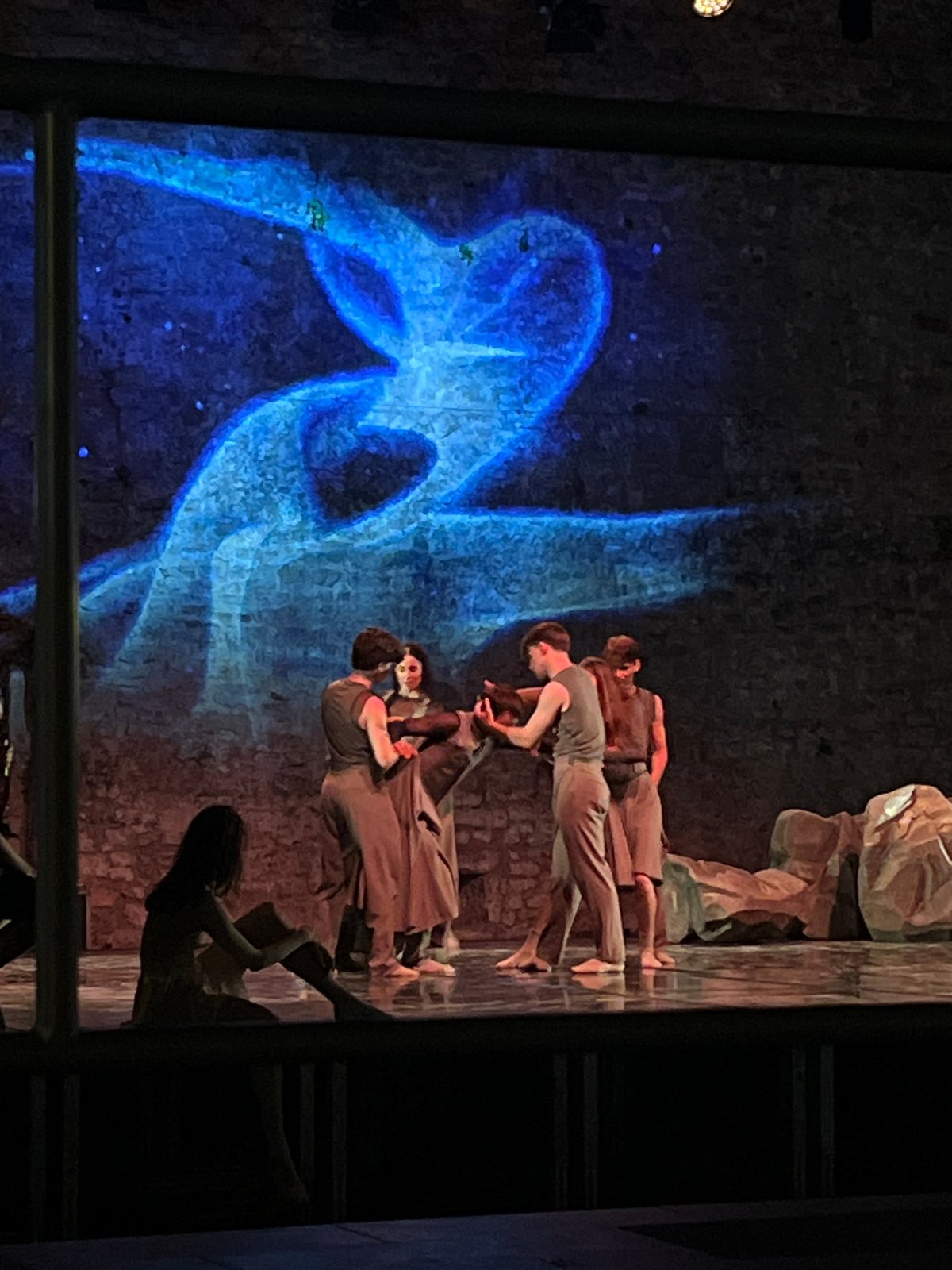 Outdoor dance performance under blue projections in Budva, Montenegro